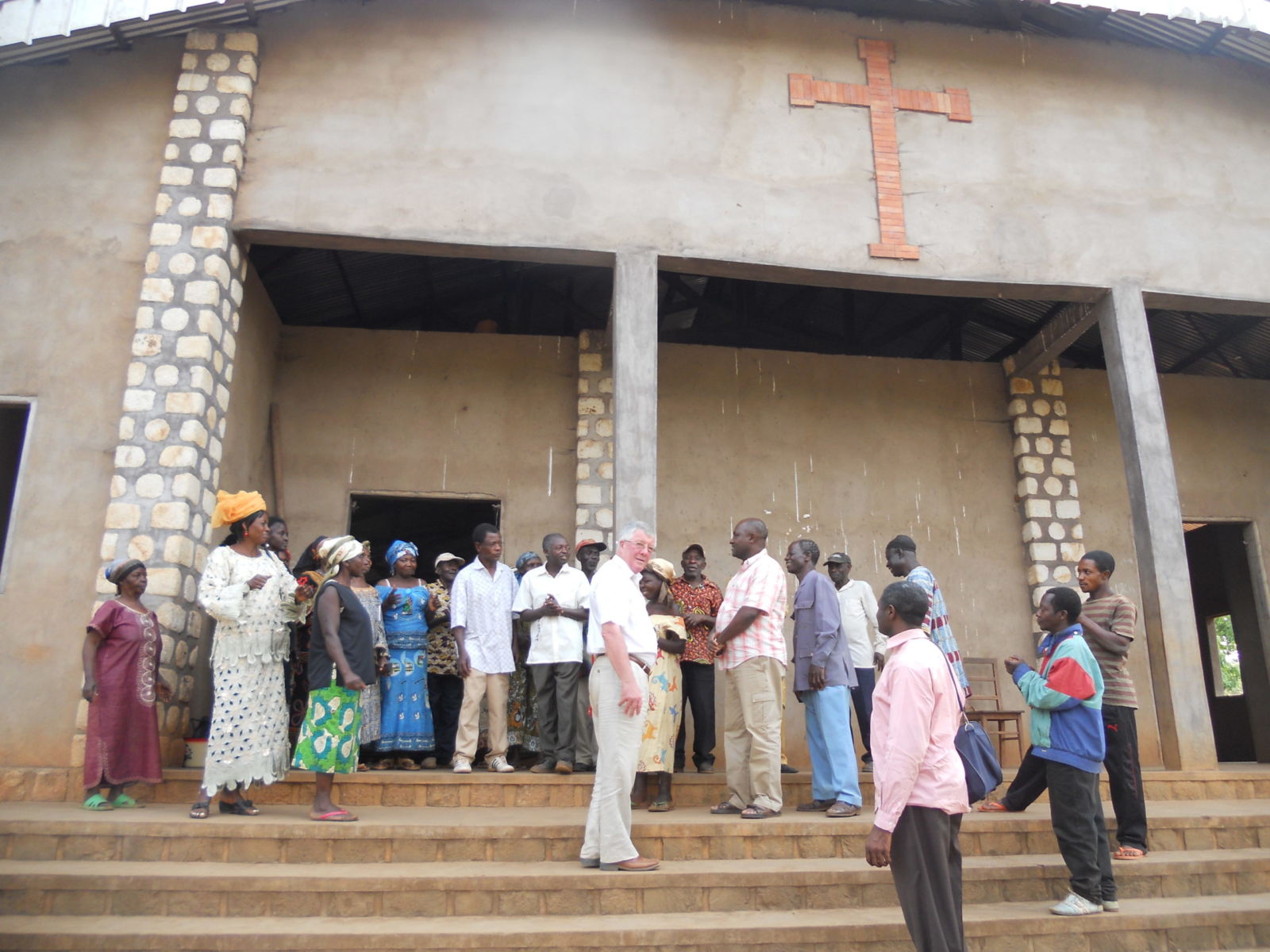 image015 Front of a grey church in Bamenda. There are some members of the congregation standing in a few steps in front of it.