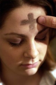 Lent-Y5-196×300 An image of a woman with a cross made of ashes in her forehead.