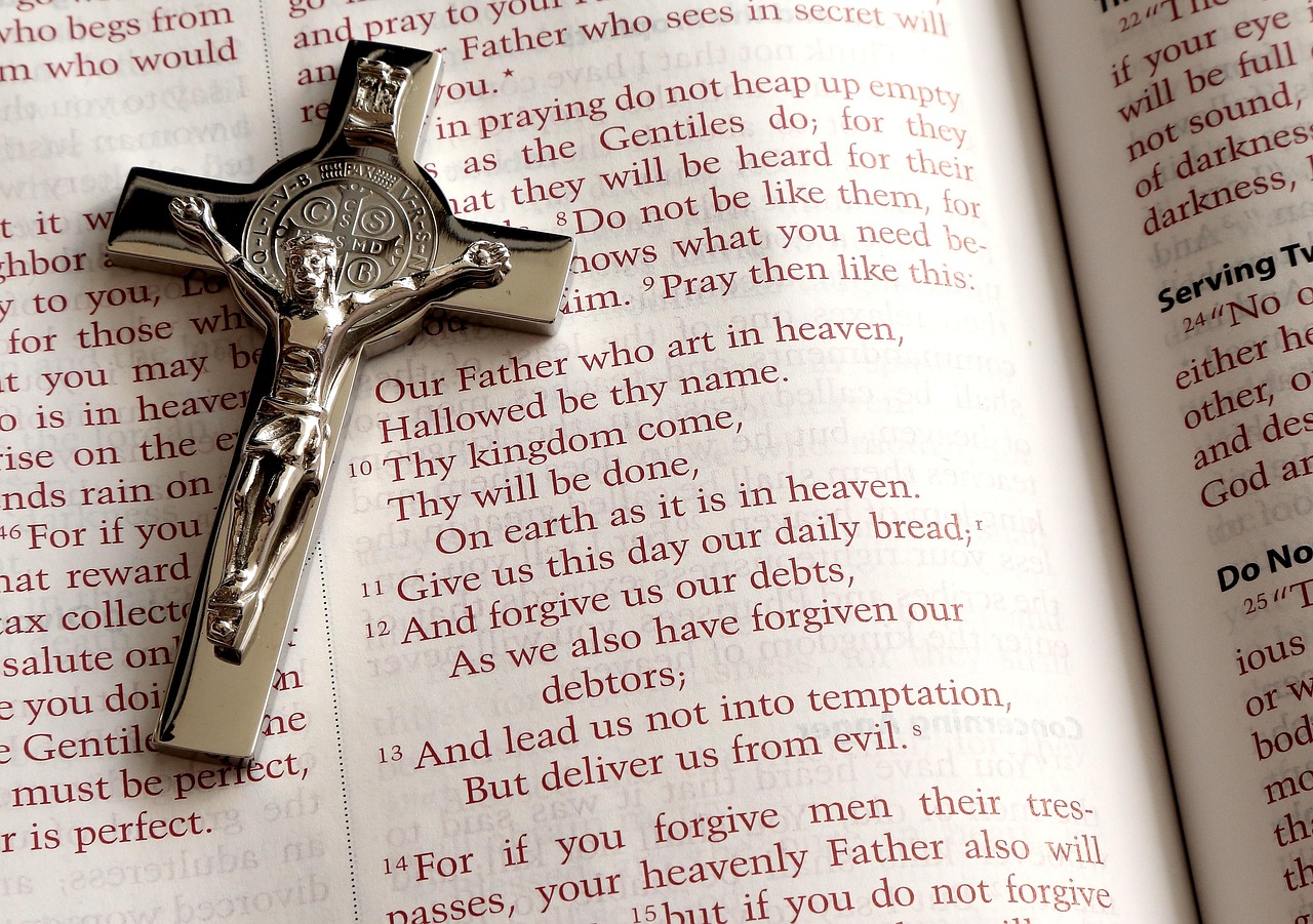 A Bible open with a cross.