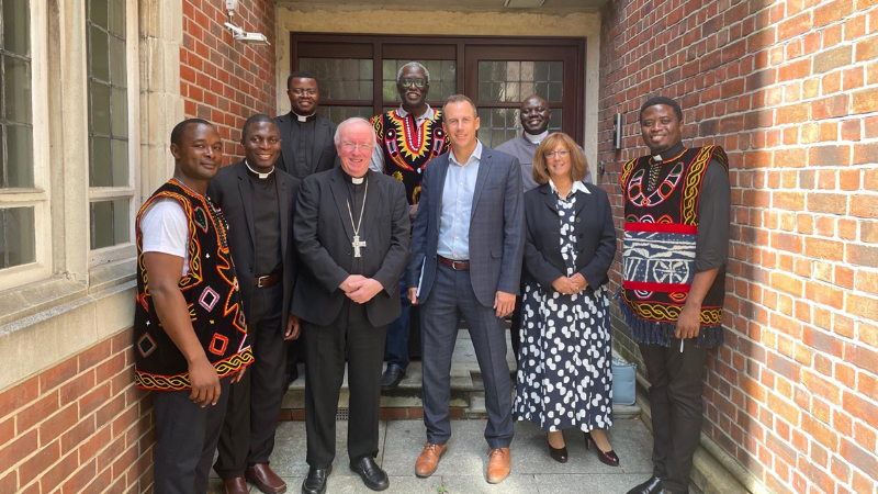 Mr Matt Woods (centre) standing with Bamenda priests, Heather Hauschild (COO of the Diocese of Portsmouth) and Bishop Philip Egan, in front of the Bishop's Office.